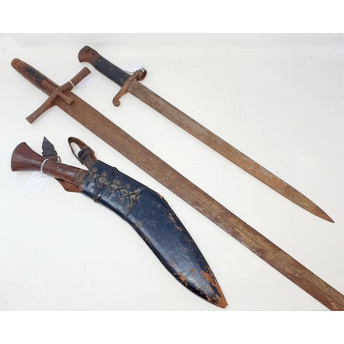 186 - An early 20th century bayonet, 59 cm long, a sword, 103 cm long, and a Kukri and scabbard, 44 cm (3)