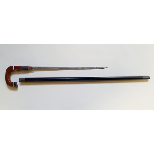 192 - A sword stick, with a trigger type release, in an ebonised stick inlaid in bone, 85 cm