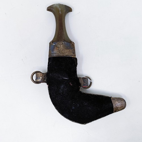 161 - A jambiya, with a horn handle and silver coloured metal mounts, 31 cm high overall