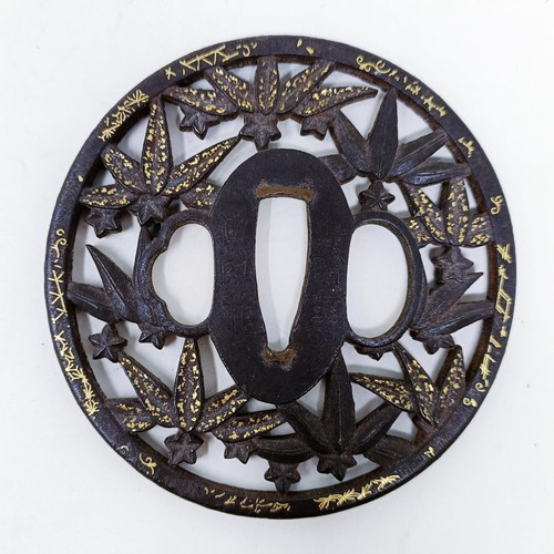 166 - A Japanese tsuba, pierced flowers and foliage and with gold inlay, signed, 8 cm