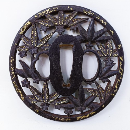 166 - A Japanese tsuba, pierced flowers and foliage and with gold inlay, signed, 8 cm