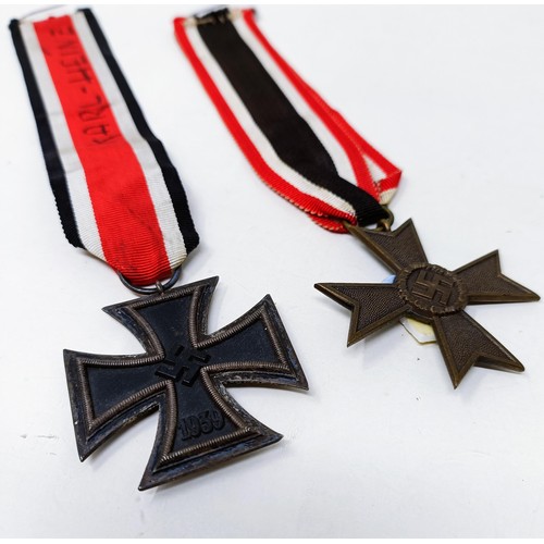 140 - A German Iron Cross 2nd Class, the ribbon inscribed Karl Heinz, and a German Third Reich War Service... 