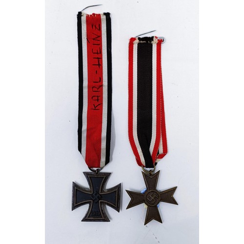 140 - A German Iron Cross 2nd Class, the ribbon inscribed Karl Heinz, and a German Third Reich War Service... 