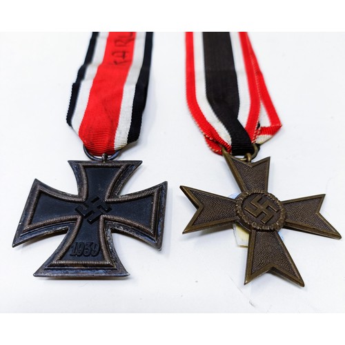 140 - A German Iron Cross 2nd Class, the ribbon inscribed Karl Heinz, and a German Third Reich War Service... 