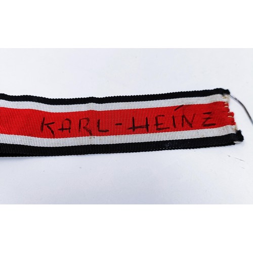 140 - A German Iron Cross 2nd Class, the ribbon inscribed Karl Heinz, and a German Third Reich War Service... 