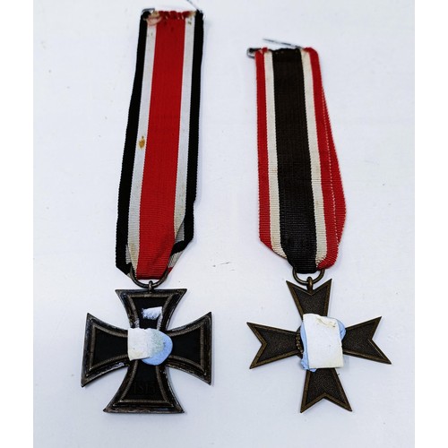 140 - A German Iron Cross 2nd Class, the ribbon inscribed Karl Heinz, and a German Third Reich War Service... 