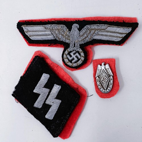 138 - A German Third Reich SS collar insignia, a similar tunic insignia, and another small badge
Provenanc... 