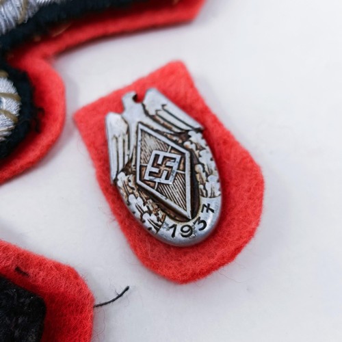 138 - A German Third Reich SS collar insignia, a similar tunic insignia, and another small badge
Provenanc... 