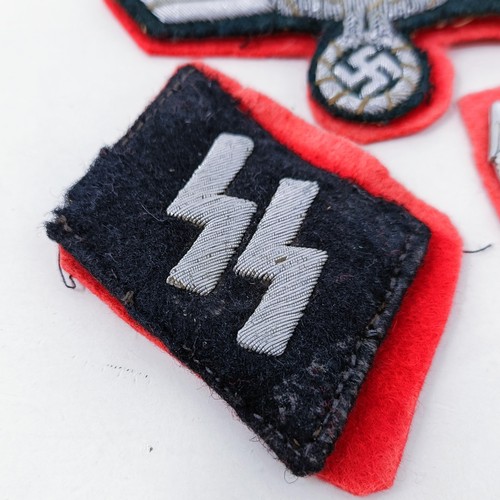 138 - A German Third Reich SS collar insignia, a similar tunic insignia, and another small badge
Provenanc... 