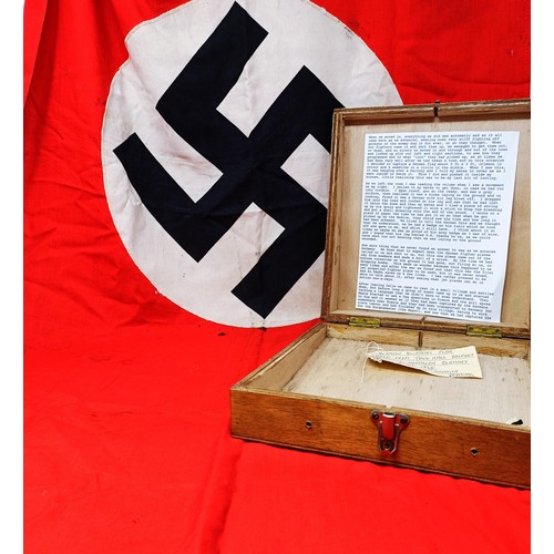 135 - A German Third Reich flag, with a swastika on a red ground, by family repute taken from town hall ba... 