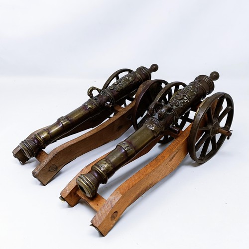 134 - A pair of Continental bronze table top cannons, drilled, the barrels 27 cm (2)