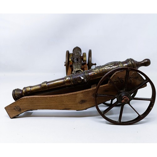 134 - A pair of Continental bronze table top cannons, drilled, the barrels 27 cm (2)