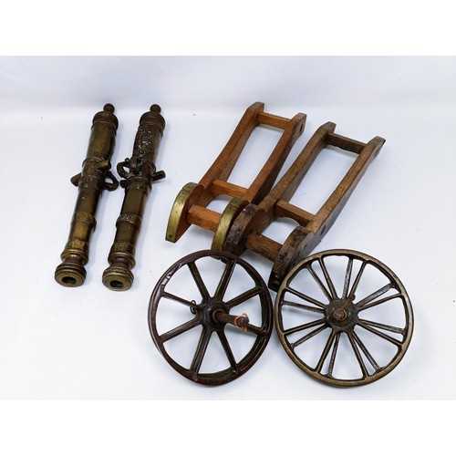 134 - A pair of Continental bronze table top cannons, drilled, the barrels 27 cm (2)