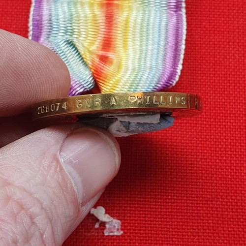 185 - A British War Medal and Victory Medal pair, awarded to 268074 Gnr A Phillips RA, mounted on a cloth ... 