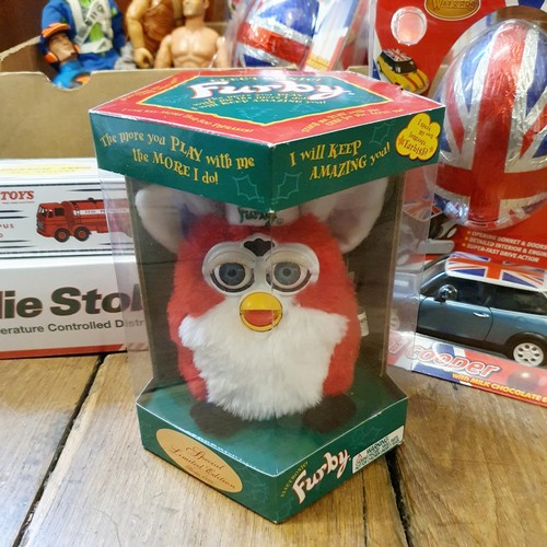 110 - A 1999 limited edition Furby, four Action Men, two Eddie Stobbart trucks, boxed, a reproduction Dink... 