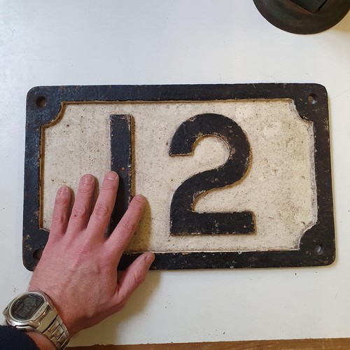 49 - A railway painted cast iron number plate, 12, 39 x 23 cm