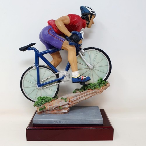 69 - An Italian porcelain cycling trophy, 36 cm high, and a resin Hill Climb trophy in the form of a cycl... 