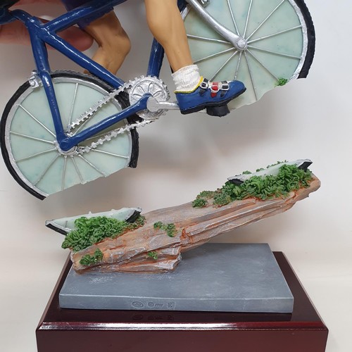 69 - An Italian porcelain cycling trophy, 36 cm high, and a resin Hill Climb trophy in the form of a cycl... 