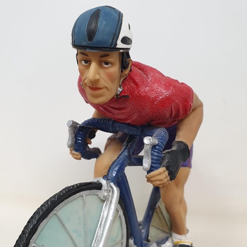 69 - An Italian porcelain cycling trophy, 36 cm high, and a resin Hill Climb trophy in the form of a cycl... 