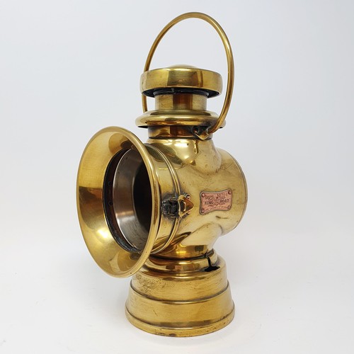 139 - An early 20th century Lucas brass oil headlamp, lacks lens, 32 cm high