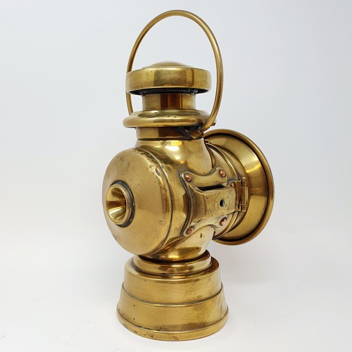 139 - An early 20th century Lucas brass oil headlamp, lacks lens, 32 cm high