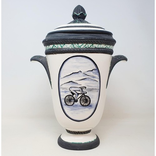 69 - An Italian porcelain cycling trophy, 36 cm high, and a resin Hill Climb trophy in the form of a cycl... 