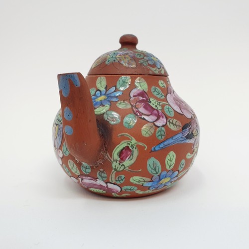 304 - A Chinese red stoneware and enamel teapot, decorated birds and flowers, impressed character mark to ... 