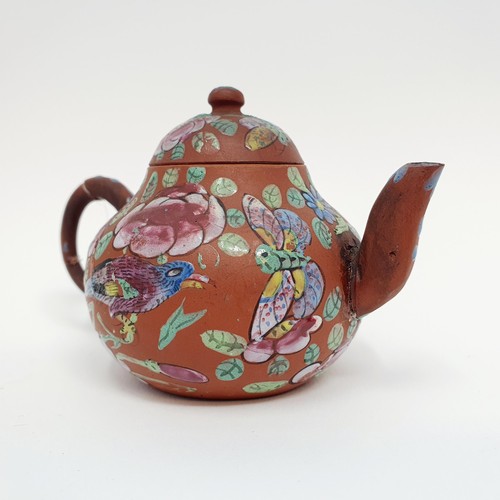 304 - A Chinese red stoneware and enamel teapot, decorated birds and flowers, impressed character mark to ... 