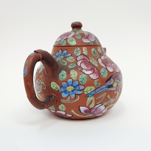 304 - A Chinese red stoneware and enamel teapot, decorated birds and flowers, impressed character mark to ... 