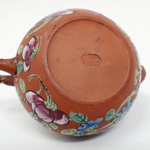 304 - A Chinese red stoneware and enamel teapot, decorated birds and flowers, impressed character mark to ... 