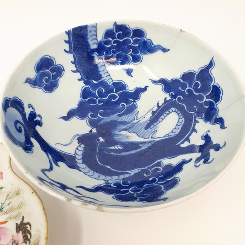 305 - A Chinese blue and white bowl, decorated dragon, six character mark to the base, 20 cm, and a shallo... 