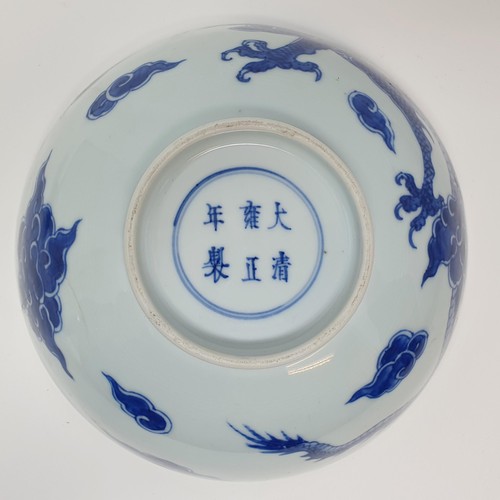 305 - A Chinese blue and white bowl, decorated dragon, six character mark to the base, 20 cm, and a shallo... 