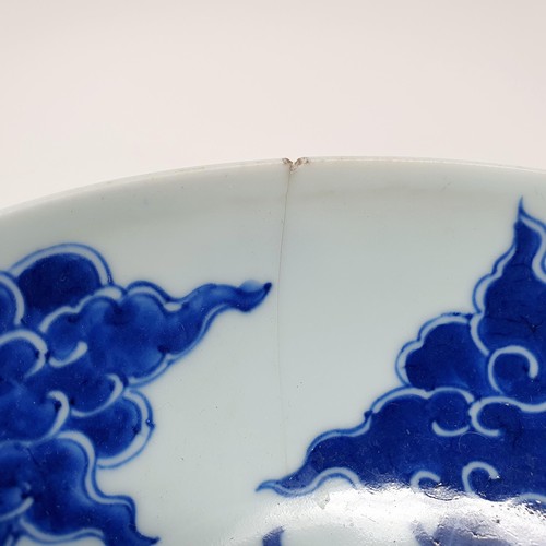 305 - A Chinese blue and white bowl, decorated dragon, six character mark to the base, 20 cm, and a shallo... 