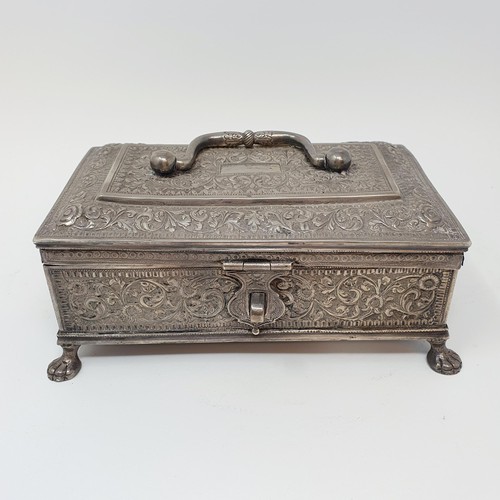 314 - An Eastern silver coloured metal casket, with a ring handle, on lion's paw feet, 18 cm wide