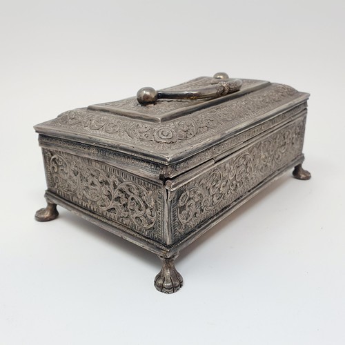 314 - An Eastern silver coloured metal casket, with a ring handle, on lion's paw feet, 18 cm wide