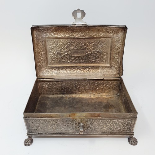 314 - An Eastern silver coloured metal casket, with a ring handle, on lion's paw feet, 18 cm wide