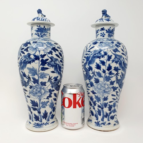 322 - A pair of Chinese underglazed blue and white vases, and covers, decorated dragons, four character ma... 