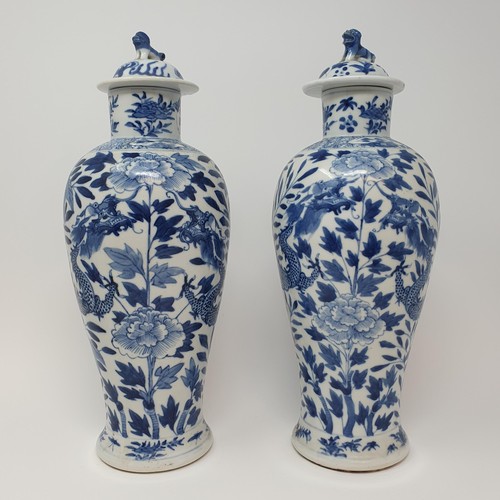 322 - A pair of Chinese underglazed blue and white vases, and covers, decorated dragons, four character ma... 