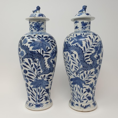 322 - A pair of Chinese underglazed blue and white vases, and covers, decorated dragons, four character ma... 