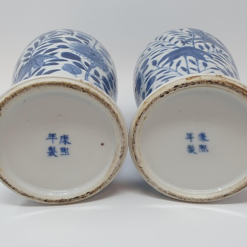 322 - A pair of Chinese underglazed blue and white vases, and covers, decorated dragons, four character ma... 