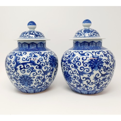 326 - A pair of Chinese underglazed blue and white vases and covers, decorated foliate forms, six characte... 