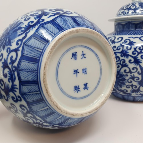 326 - A pair of Chinese underglazed blue and white vases and covers, decorated foliate forms, six characte... 