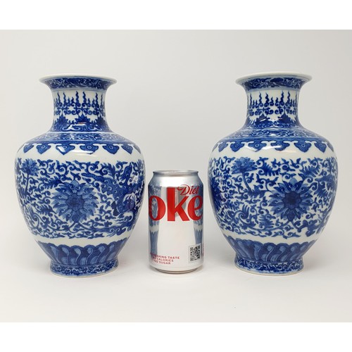 320 - A pair of Chinese underglazed blue and white vases, decorated mythical beasts and flowers, character... 