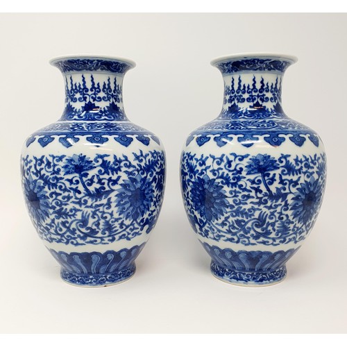 320 - A pair of Chinese underglazed blue and white vases, decorated mythical beasts and flowers, character... 