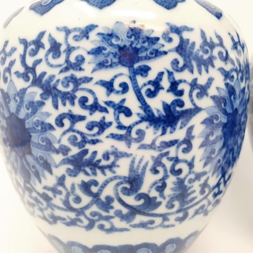 320 - A pair of Chinese underglazed blue and white vases, decorated mythical beasts and flowers, character... 