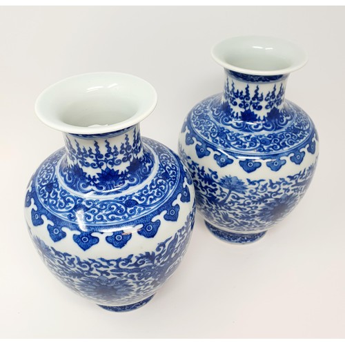 320 - A pair of Chinese underglazed blue and white vases, decorated mythical beasts and flowers, character... 