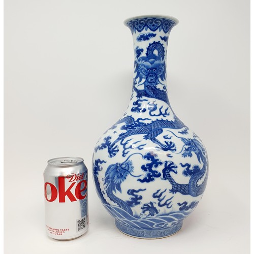 330 - A Chinese underglazed blue and white vase, decorated dragons, 35 cm high