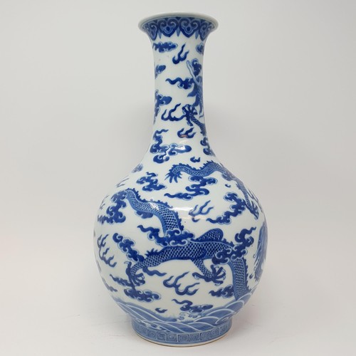 330 - A Chinese underglazed blue and white vase, decorated dragons, 35 cm high