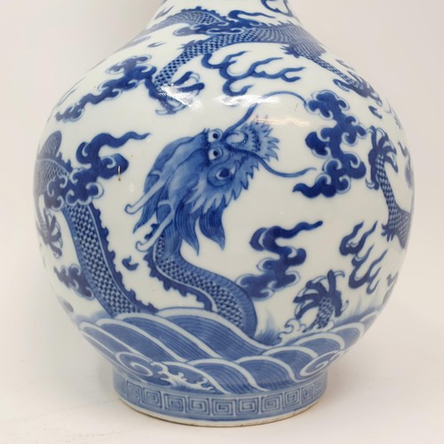 330 - A Chinese underglazed blue and white vase, decorated dragons, 35 cm high