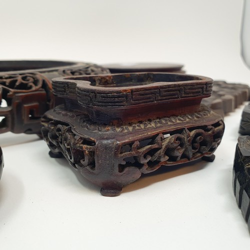 332 - A Chinese carved hardwood stand, 20 cm diameter, and six others similar (7)